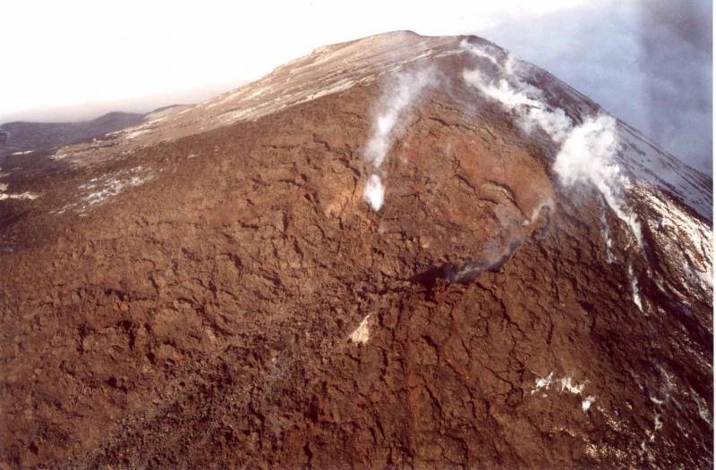 The summit vent of Cleveland volcano.   Lava is being extruded and feeding a blocky lava flow down the west flank that reached and entered the sea.