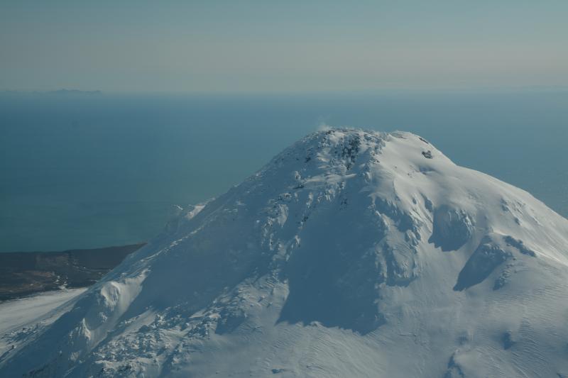 Aerial view from the north-northwest of Augustine Volcano.  Steam is visible rising from fumaroles on the 2006 summit lava dome.  Photo taken during the annual Cook Inlet gas measurement flight.
