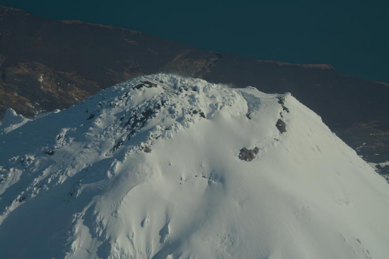 Aerial view of the upper west summit area of Augustine Volcano.  Bare ground marks fumaroles on the 2006 lava dome and warm ares on the south rim.