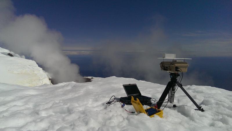 AVO and USGS scientists visited the summit of Augustine on June 7, 2015, to determine an appropriate site for a new summit station and to make SO2 camera measurements of the fumaroles in the summit area.  This image shows the SO2 camera aimed at a fumarole on south side of Augustine summit.