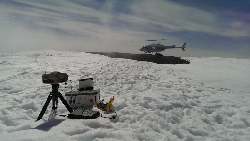 Gas measurement fieldwork on Augustine Volcano, June 7, 2015. SO2 camera with helicopter landing zone in background. The snow-free area extends for at least 100 m to the south (left in this image).