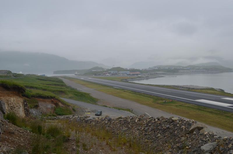 Dutch Harbor&#039;s runway, with ash deposits from Makushin volcano visible in outcrop. 