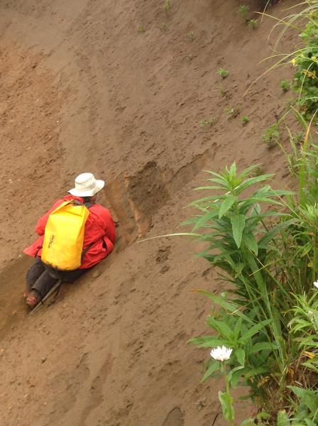 USGS geologist, Jim Vallance, investigates ash fall and pyroclastic flow deposits in Waterfall Valley, on the north flank of Makushin volcano.