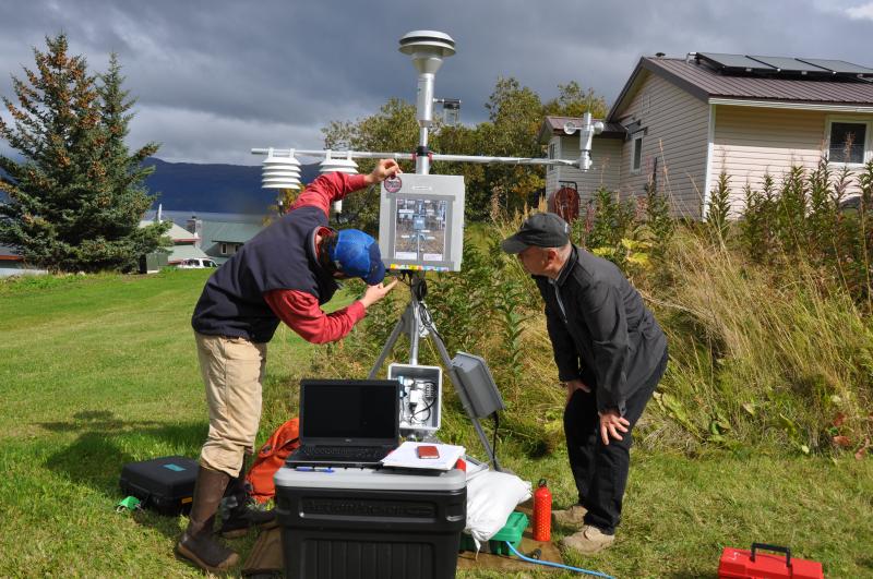 AVO staff Mark Hansen working with Larsen Bay Mayor David Harmes on how the operation of AVO-4 particulate monitor.