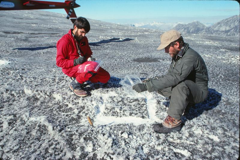 Wille Scott (CVO) and Game McGimsey (AVO) collecting a measured-area tephra sample from snow near Redoubt Volcano.  The ash was from the April 21, 1990 eruption of Redoubt (see image 379).