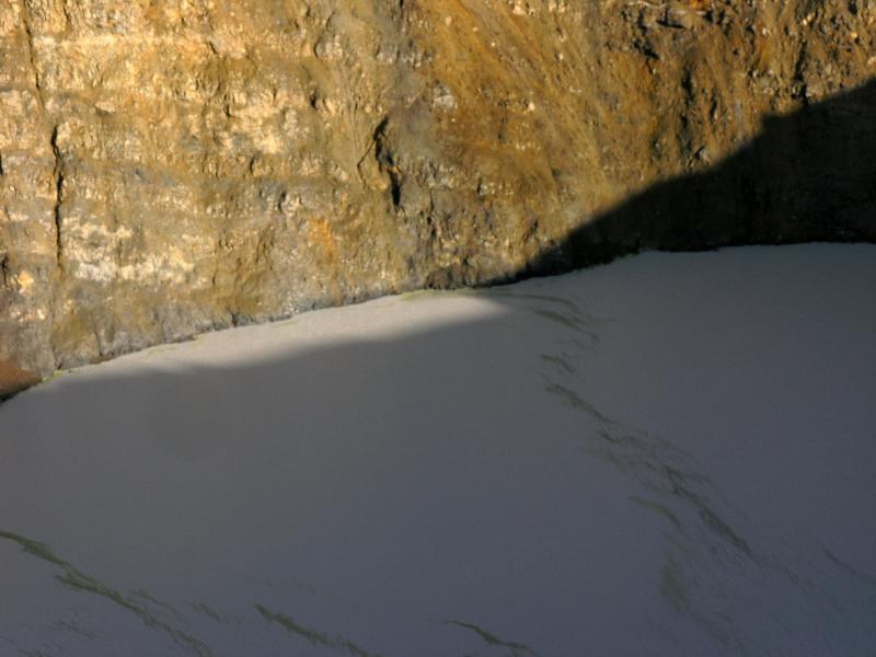 Strings of yellow sulfur precipitate in the crater lake water at Chiginagak volcano.