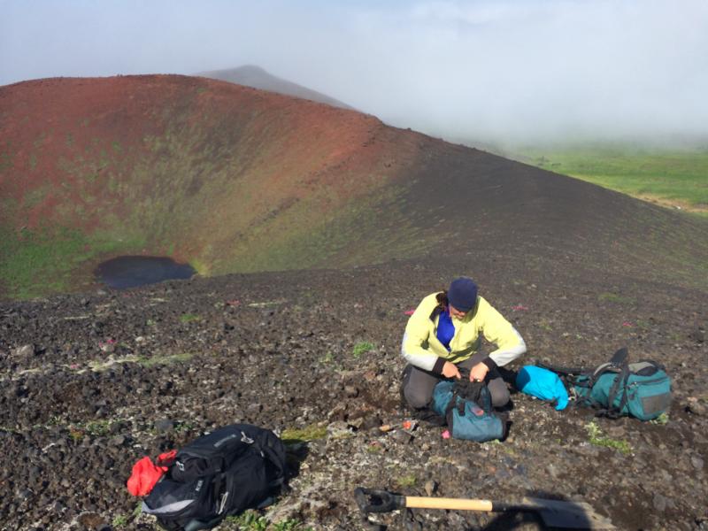 AVO/DGGS Geologist, Janet Schaefer, sampling tephra on a cinder cone on the west flank of Vsevidof volcano.  AVO Station 16JRSVS001.