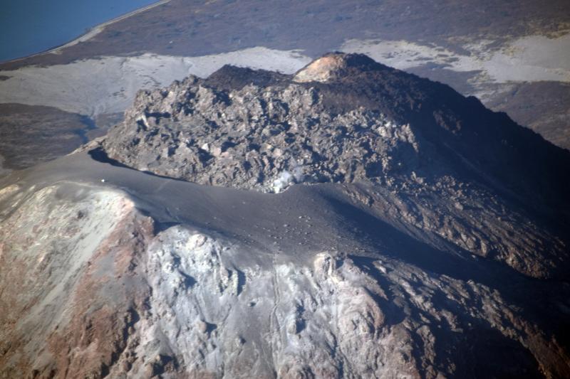 Aerial view of the summit of Augustine Volcano showing the 2006 lava dome and tephra rampart.  View is of the upper southeast-east flank; image taken during the annual Cook Inlet  volcanoes gas-measuring flight.