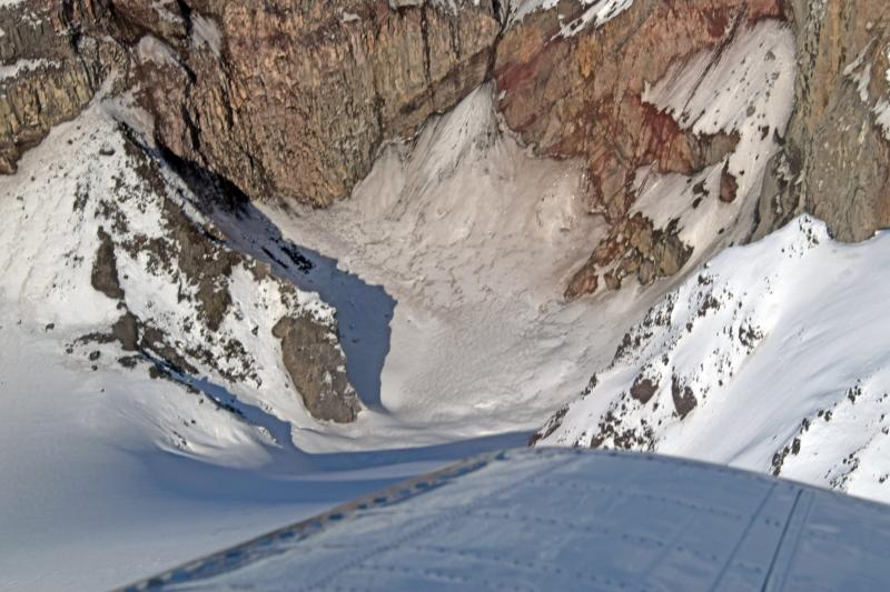 Aerial view from the south down into the bottom of Crater Peak, satellite vent on Mt. Spurr volcano.  This view shows snow covering the bottom of the crater with no sign of fumarolic activity.  Image taken on the annual Cook Inlet volcanoes gas-measuring flight.