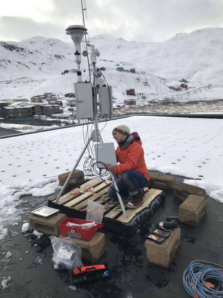 Kristi Wallace, AVO/USGS, installs an air quality monitor in Unalaska.
