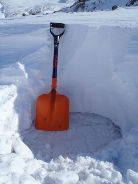 Photo showing the Bogoslof ashfall deposit from 31 January 2017 as seen on 19 February during a sampling expedition on the west side of Unalaska Island.  Wind and exposure to sunlight since the ashfall event has caused the ash to be encased in recrystallized firn snow. Samples were collected at nine locations across the island. Only trace amounts of ash were found at all sites (trace = less than 1/32 of an inch or less than 0.8 mm).  