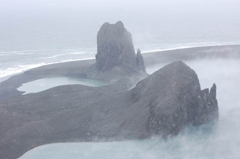 Pre-existing dome remnants on the NW end of Bogoslof Island and the vent/crater now filled by a warm saltwater lake. Bogoslof Island aerial recon opportunity courtesy of U.S. Coast Guard Air Station Kodiak and U.S.C.G Cutter Mellon.