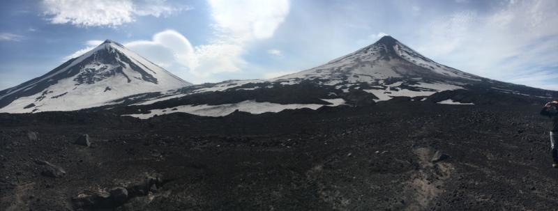 Panoramic photo of Pavlof Volcano (right, with minor vapor plume) and Pavlof Sister (right). Photo taken July 17, 2017, by Jessica Larsen, UAFGI/AVO.