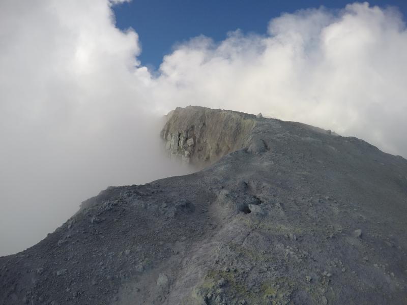 Active fumaroles and yellow sulfur deposits around the summit crater at Makushin volcano.