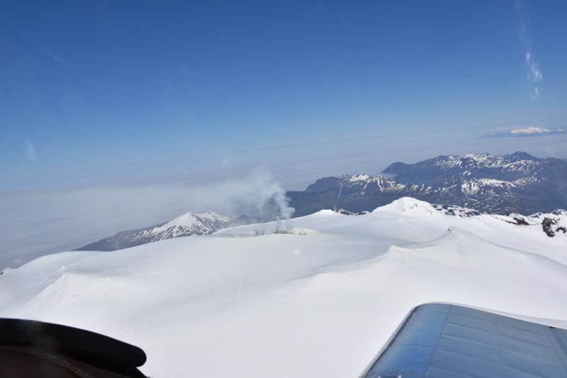 Oblique airphoto of Makushin Volcano, viewed from the west, taken June 12, 2018. Akutan Island is in the far background. Photo courtesy of Vlad Karpayev. 
