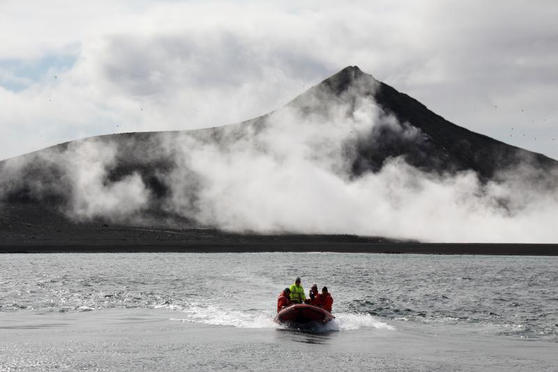 Day 1 of Bogoslof field work in August 2018. Skiff returning to ship with steaming 2016-17 dome and fumaroles in background.