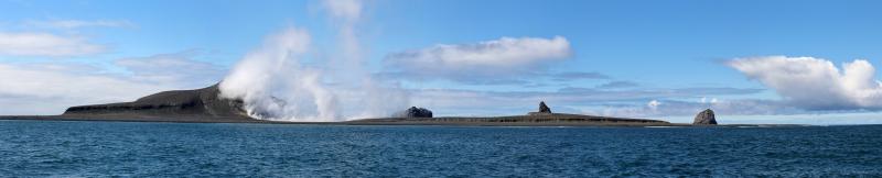 Day 2 of Bogoslof field work. Panorama of Bogoslof Island facing west. Left to right: southern shelf, steaming 2016-17 dome, south northern shelf, 1926-27 dome, north northern shelf, 1992 dome, Fire Island.