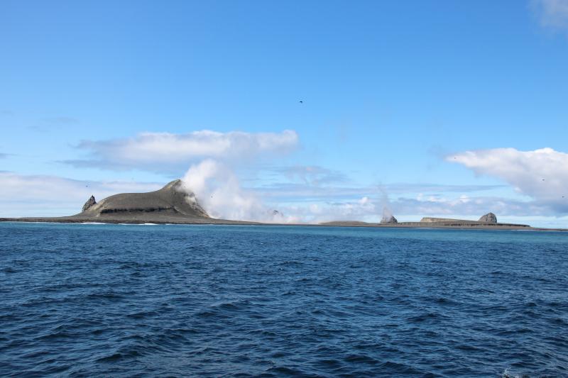 Day 2 of Bogoslof field work. View of Bogoslof Island showing all of the domes. Left to right: Castle Rock, steaming 2016-17 dome, 1926-27 dome (largely obscured by steam), 1992 dome, and Fire Island. Taken facing northwest.