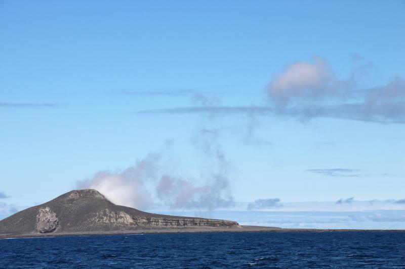 Day 2 of Bogoslof field work. Steam plume emanating from 2016-17 dome. View facing north. Castle Rock visible on left, southern shelf near center.