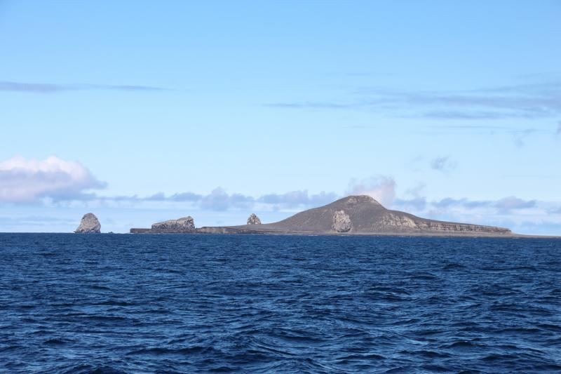 Day 2 of Bogoslof field work. Bogoslof Island viewed from ship facing northeast. Left to right: Fire Island, western beach cliffs, 1926-27 dome, 1992 dome, Castle Rock, back of steaming 2016-17 dome, and southern shelf.