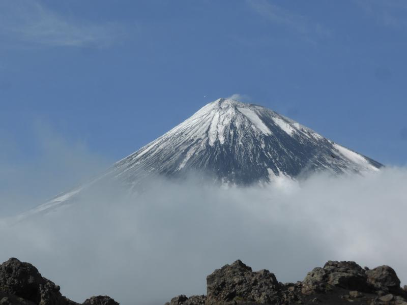 Shishaldin Volcano from the south.  Helicopter near the summit for scale.  Look for the bald eagle.