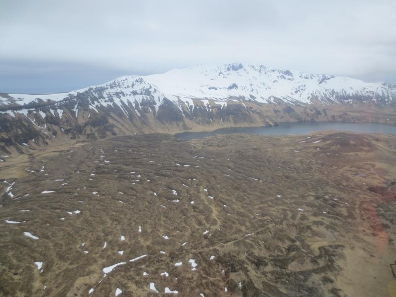 View of the northern part of the caldera.  An old lava flow from Mt Cerberus can be seen flowing to the NE down toward Fenner Lake at the foot of Perret Ridge.  Photos of Semisopochnoi Island taken in May 2017 during AVO station maintenance activities and supported by U.S. Coast Guard.  