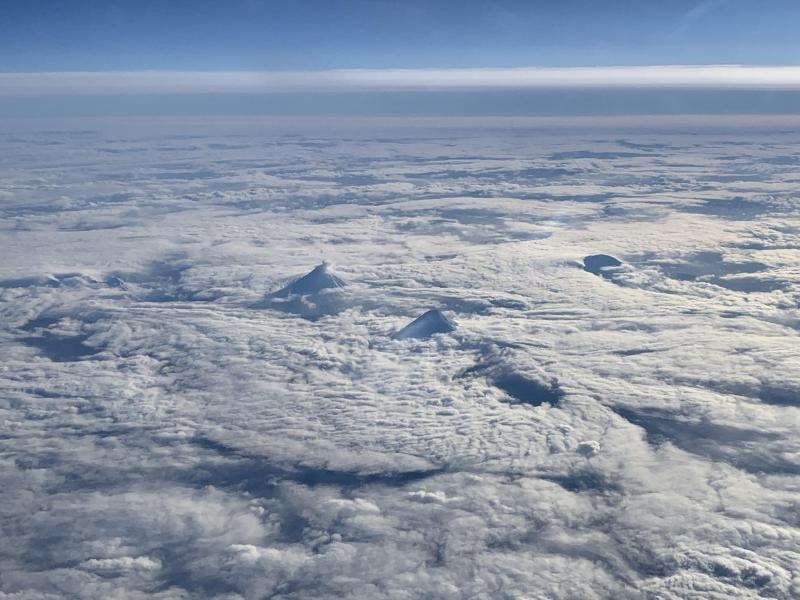 Alaska Airlines pilot Dave Clum took this photo of the Islands of the Four Mountains on the afternoon of Saturday, January 19, 2019. A small steam plume at the summit of Cleveland volcano is visible in the middle of the photo. 