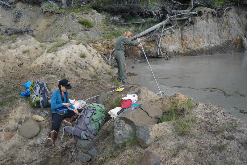 Taryn Lopez &amp; Valerie Wasser collect a gas sample from Shrub Volcano&#039;s summit pond.