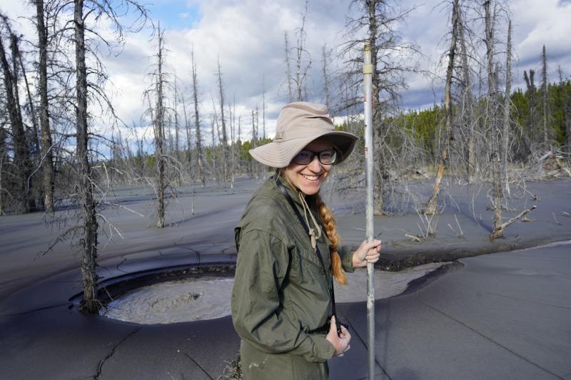 Valerie Wasser stands in front of main degassing vent at Shrub Volcano&#039;s North flank mud eruption site.