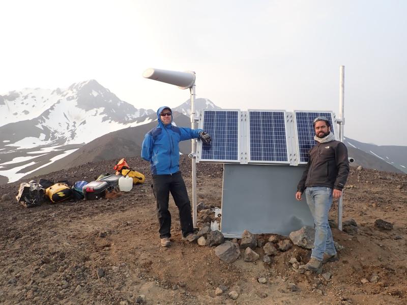 John Lyons (AVO-USGS) and Ricky Garza (UCSC) at the upgraded seismic station KOFP, SE of Kliuchef volcano on Atka Island. Strong winds and blowing dirt made this a challenging installation.