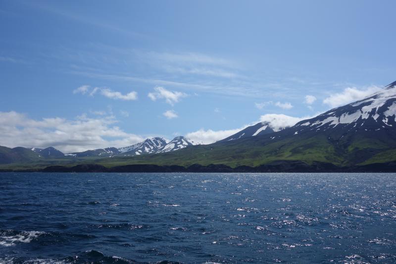 Northeast shore of Atka. Volcanic features from left to right are Kliuchef (2 peaks near center of image), Konia (top obscured by clouds) and the lower NE flank of Korovin (far right). Photo taken from the M/V Steadfast.
Station ID = 19AAJRS004