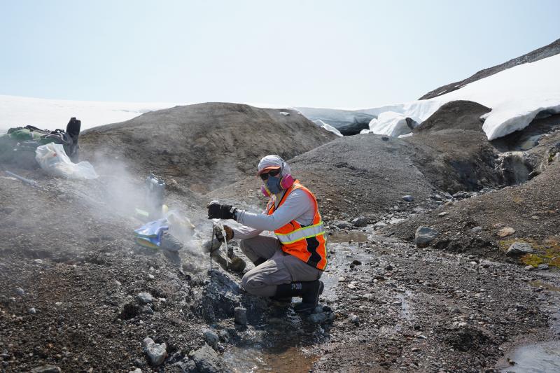 Peter Kelly (USGS) collects a gas sample on the SE flank of Klichef volcano.