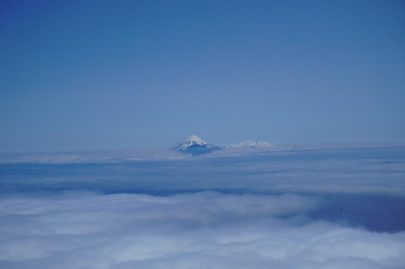 View of Tanaga and Takawangha volcanoes above the clouds as seen from Gareloi volcano.