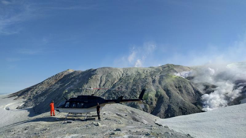 USGS geologist Allan Lerner and pilot Kevin Franks make observations of degassing from fumaroles on the north flank of Makushin Volcano&#039;s summit crater. 