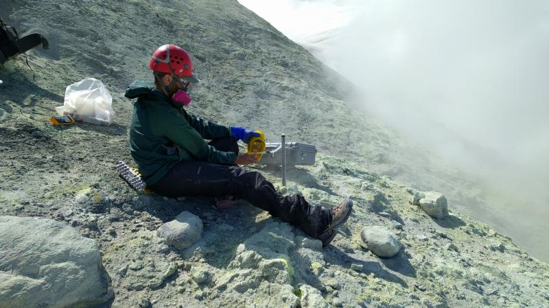 USGS gas geochemist Allan Lerner samples gas emissions from a fumarole near the summit of Makushin Volcano.