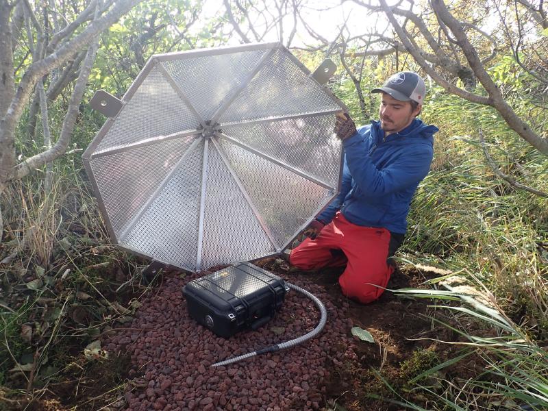 Upgrade of AVO&#039;s Sand Point infrasound array,  Oct 2019.
This 6-element listening array is designed to detect explosive activity at Pavlof Volcano, 90km (56 mi) to the west.  Alder groves provide excellent protection from the winds on Popof Island.  The perforated aluminum cone covers the box and helps reduce wind noise.