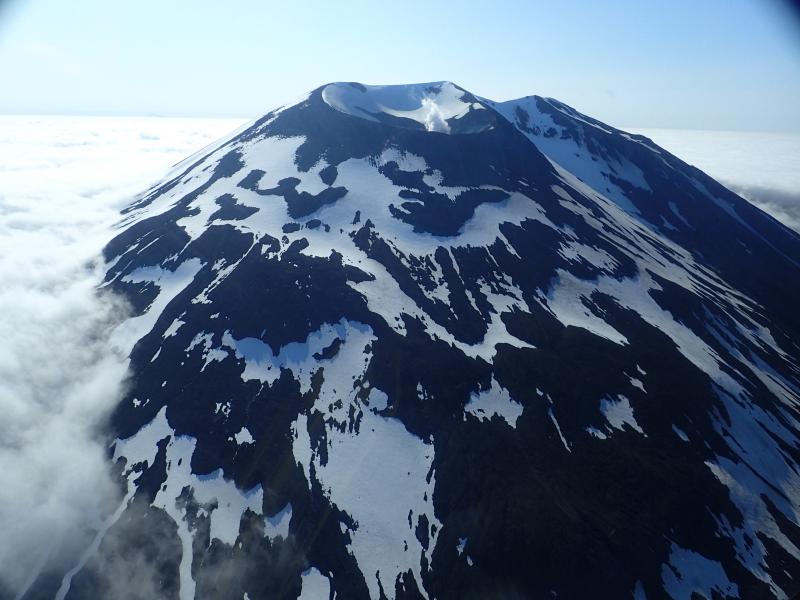 View of Korovin Volcano during a helicopter flight to measure gas emissions. Note the small vapor plume emanating from the crater.