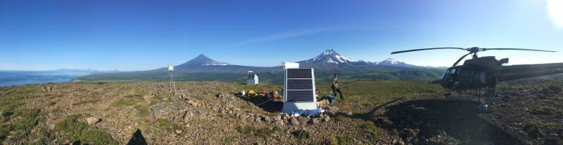 Shishaldin, Isanotski, and Roundtop volcanoes viewed from geophysical station BRPK. Malcolm Herstand in center. Photo courtesy of Allan Lerner, USGS.