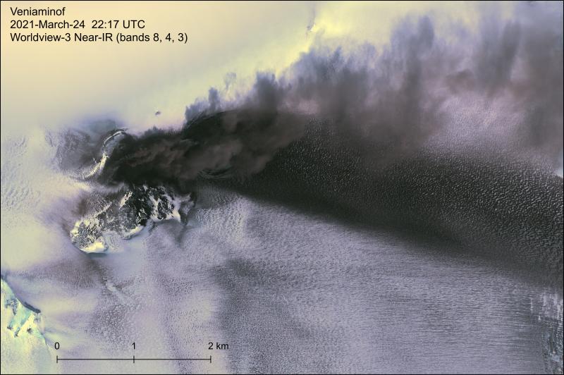 Worldview-3 near-IR satellite image of the Veniaminof eruption on March 24, 2021. Tephra deposits and an active ash plume are visible to the east of the summit cone. The 2018 lava flow field is visible south of the cone, while the 2021 lava flow ice cauldron is mostly obscured by the plume. 