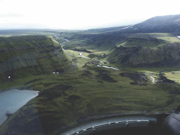 Oblique air photo showing the Okmok gates region and Crater Creek. The thick sequence of the Crater Creek basalts lava flows is on the left and right sides of the photos, on either side of the Crater Creek.