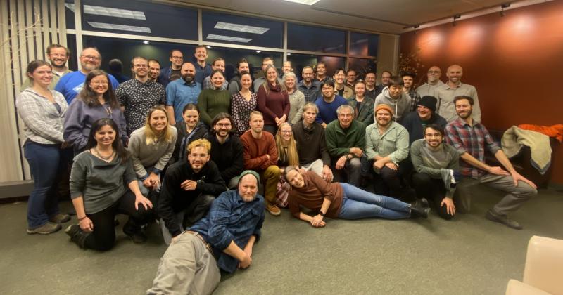 Attendees of the December 5-6, 2022, AVO Coordination Meeting in Anchorage. Back row(s): Alex Iezzi, Matt Loewen, Dave Schneider, Dennis Staley, Skye Kushner, Liam Toney, Matt Haney, Israel Brewster, Danny Coulthard, Dawnika Blatter, Aaron Wech, Steve Smith (in hat and partly behind Aaron), Charlie Mandeville, Darren Tan, Jonathan Godt, Charles Olin, Tom Parker, Wyatt Mayo, Steve Botnick, and David Fee. Second row: Cheryl Cameron, Jordan Lubbers, Max Enders, Claire Pulieo, Taryn Lopez, Jessica Larsen, Kate Bull, Yitian Cheng, Hannah Ronsencrans, Kyungmin Kim, Nick Frearson, Dane Ketner. Third row: Diana Roman, Kristina Walowski, Ellie Boyce, Conor Bacon, John Lyons, Valerie Wasser, Max Kaufman, John Power, Dave Hyman, Mario Angarita. Front row: Pablo Saunders-Schultz, Cyrus Read, and Michelle Coombs. Not pictured because they attended virtually or in part, or had to leave early: Pavel Izbekov, Hans Schwaiger, Rob Sanders, Mark Stelten, Chris Waythomas, Seth Burgess, Mariah Graham, Simon Plank, Einat Lev, Mike Randall, Jim Vallance, Allan Lerner, Hannah Dietterich, Jenny Nakai, Christoph Kern, Alison Koleszar, Josh Crozier, Tom Murray, Nate Graham, Paul Earle, Benny Benavidez, Terry Plank, Cheryl Searcy, Malcolm Herstand, Scott Graham, Greg Vaughan, Cindy Werner, Andy Calvert, Peter Kelly, Dave Harvey, Tina Neal, Jeremy Pesicek, Jay Wellik, Stephanie Prejean, Jamshid Moshrefzadeh.