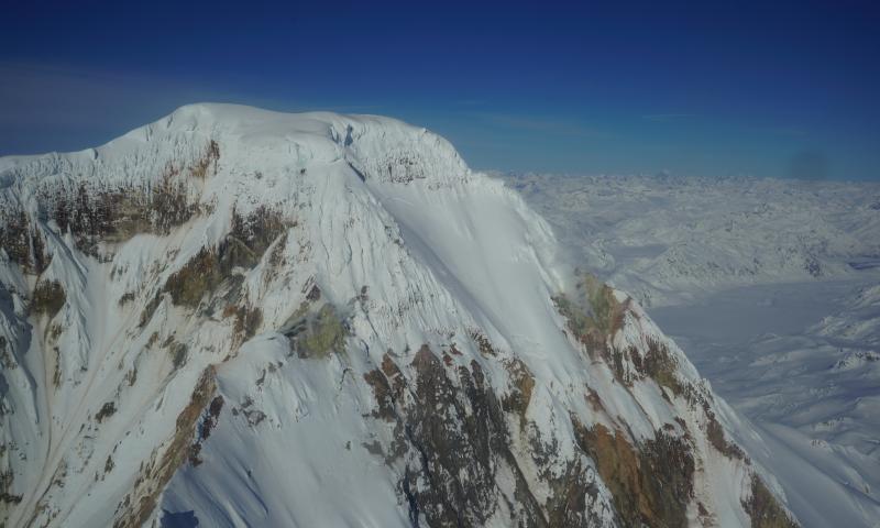 Aerial view of Iliamna&#039;s summit with degassing from fumarole fields seen in image center and center right.