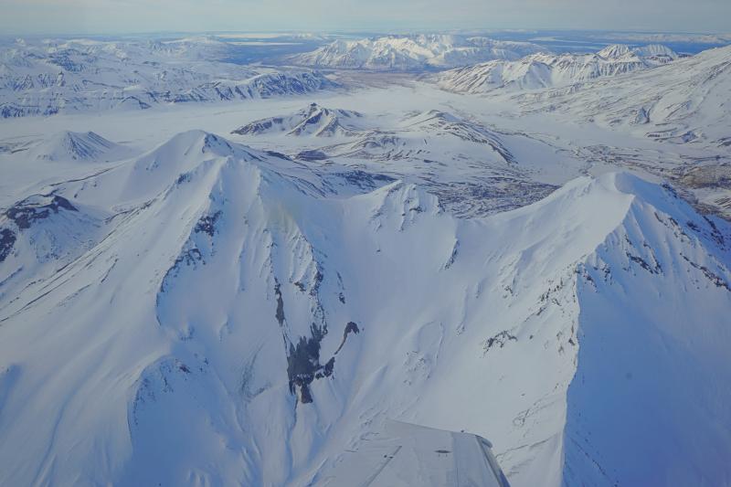 Aerial view of Trident volcano as viewed from the south. The southeast fumarole field on Trident I is visible in lower center of the image. The Valley of Ten Thousand Smokes can be seen in the background.