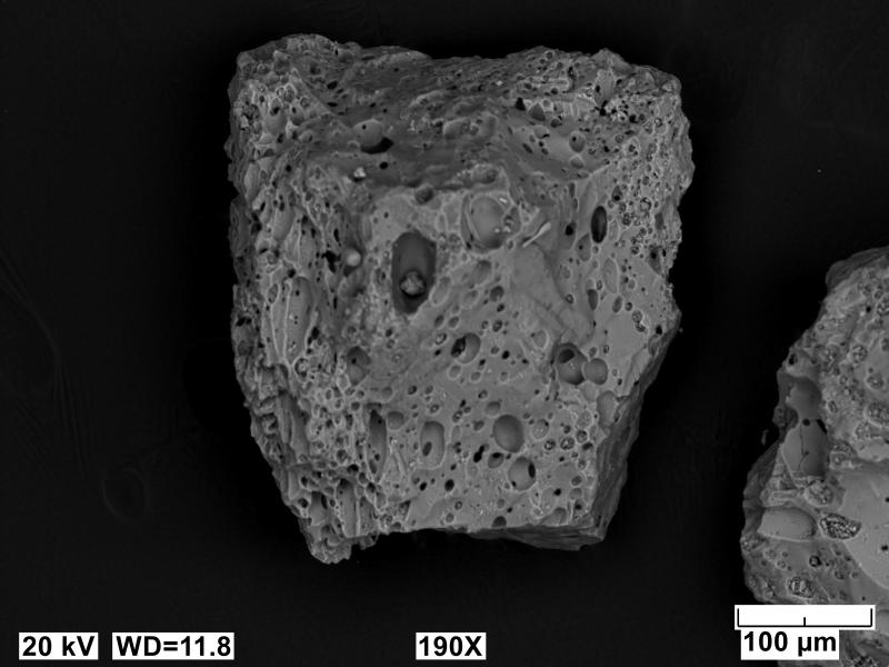 SEM image of ash particle from V2 pyroclastic-flow deposit at Veniaminof Volcano. Image acquired on an JEOL 6510LV SEM at 10 kV, 12 mm working distance, spot size of 65, and in BES imaging mode.