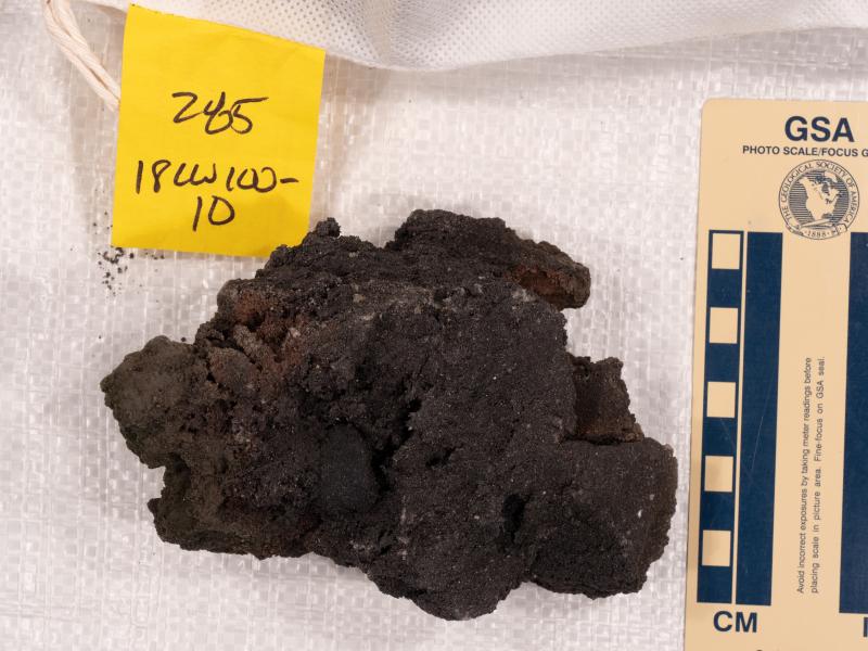Photo of sample 18CW100-10 collected in August 2018 from the 2016&ndash;2017 Bogoslof eruption. This sample is a typical basalt scoria clast from the eruption.