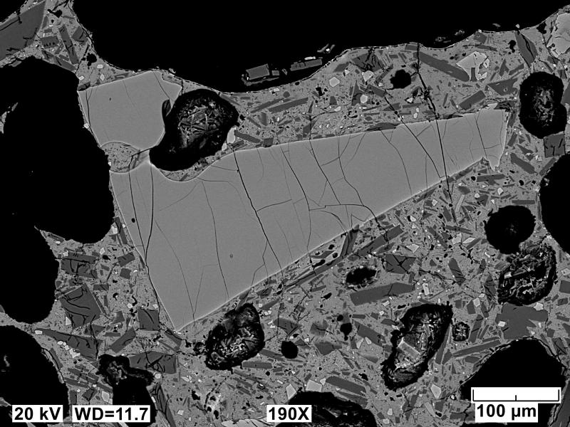 Backscatter electron polished mount image of an Edgecumbe basalt scoria clast (sample 81ARJ073A). Image includes a rare larger olivine phenocryst. Image acquired on an JEOL 6510LV SEM at 20 kV, 12 mm working distance, spot size of 65, and in BEC imaging mode.