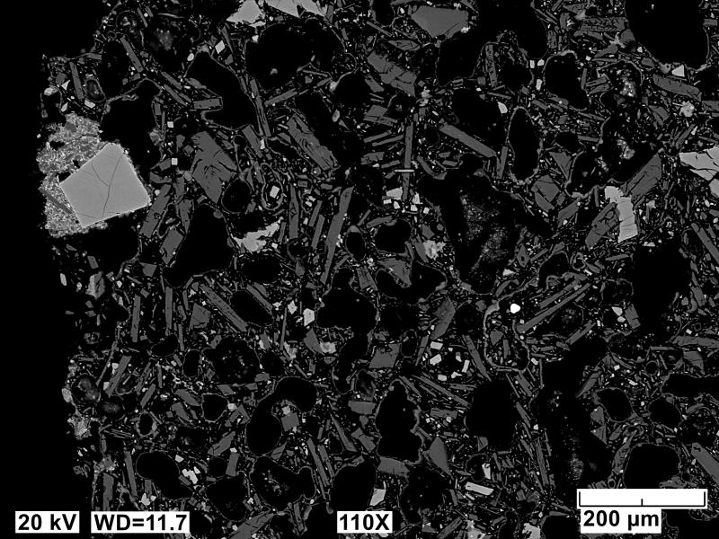 Backscatter electron polished mount image of an Edgecumbe basalt scoria clast (sample 81ARJ073A). This image is of an the &#039;orange&#039; component of this tephra sample. The glass has been entirely altered leaving a porous matrix of crystals and no original glass. Image acquired on an JEOL 6510LV SEM at 20 kV, 12 mm working distance, spot size of 65, and in BEC imaging mode.