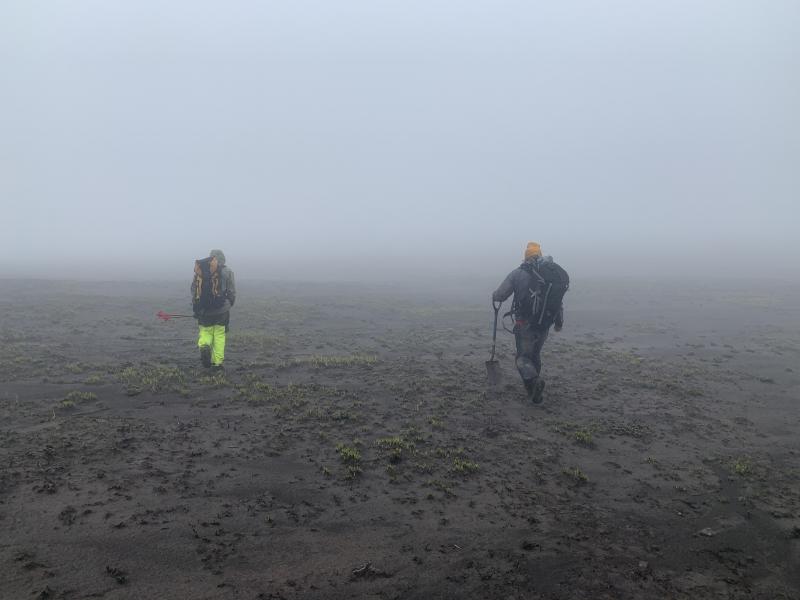 AVO field engineers hiking across the caldera to seismic station CERB, Semisopochnoi Island, western Aleutians.  