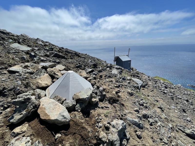 AVO field team repairing an infrasound sensor at site GASW, Gareloi Volcano, Andreanof Islands, western Aleutians.