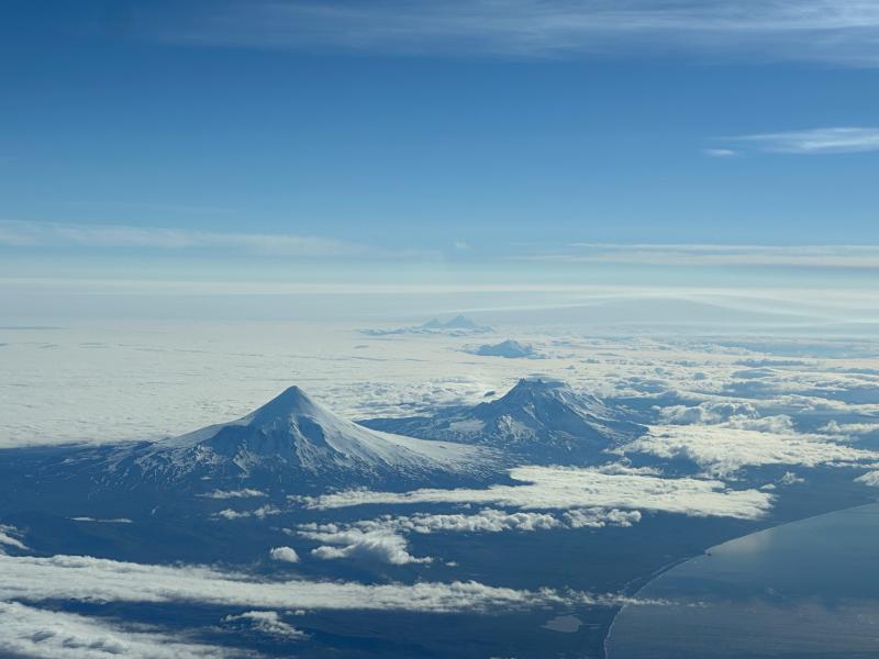 From front to back: Shishaldin Volcano, Isanotski, Roundtop, Frosty, and Pavlof/Pavlof Sister volcanoes. Photo taken from the air, July 11, 2023.
